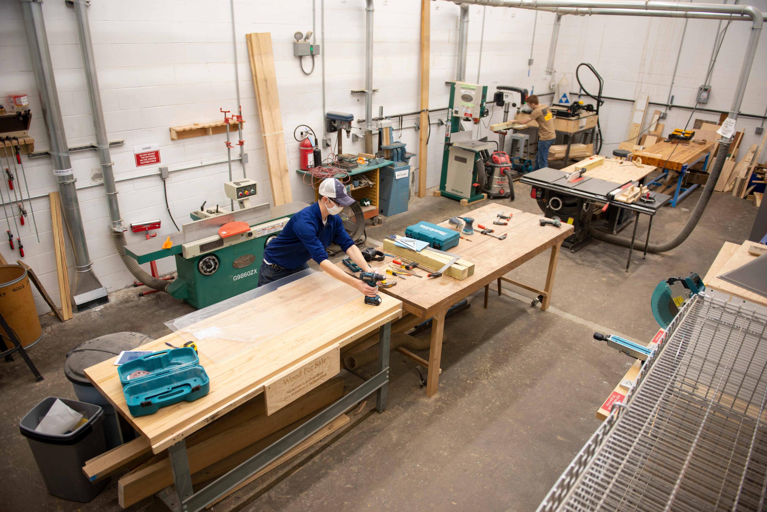 Students work to build a green roof model at the Athens Maker Space.