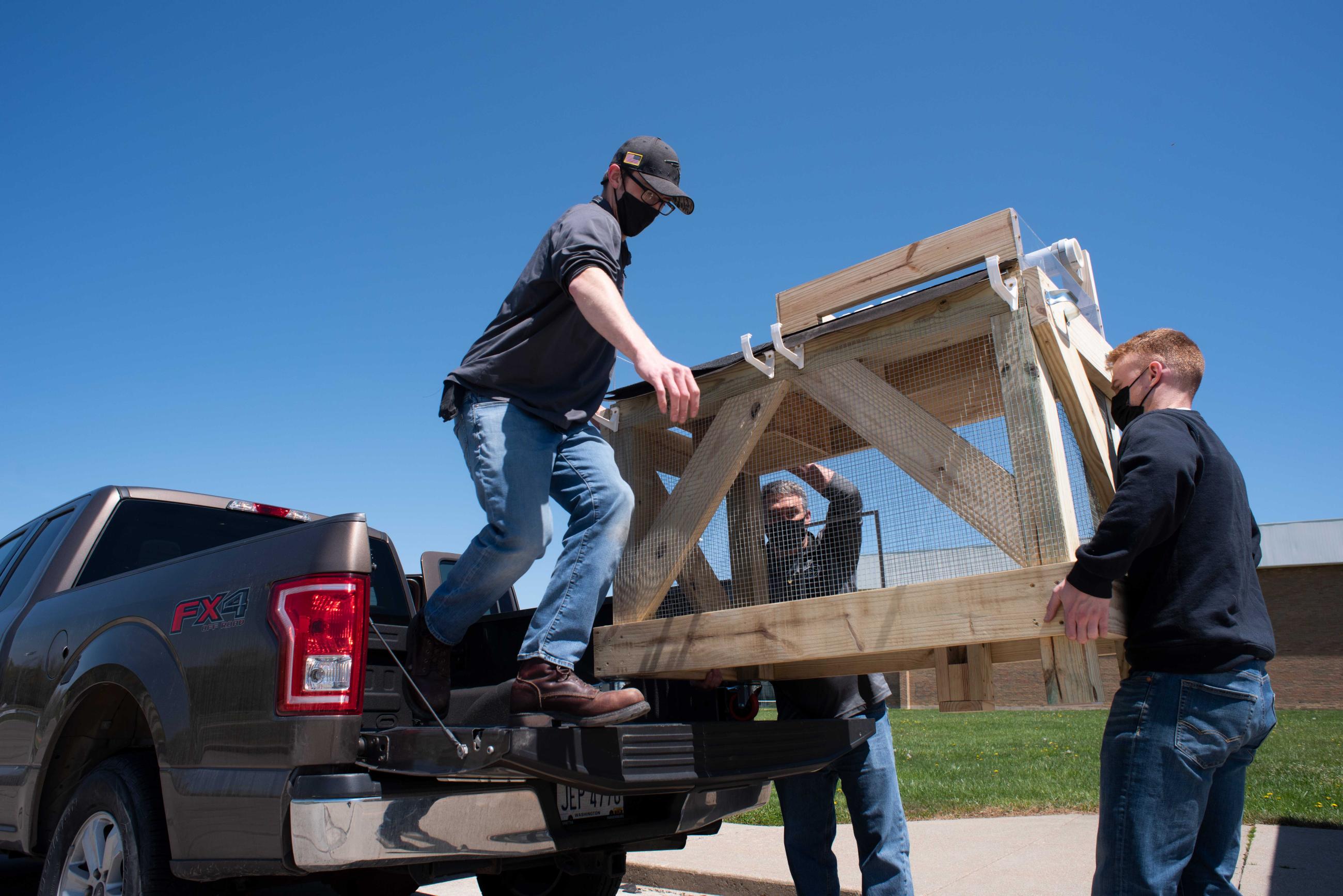Students unload a green roof model at Athens High School.