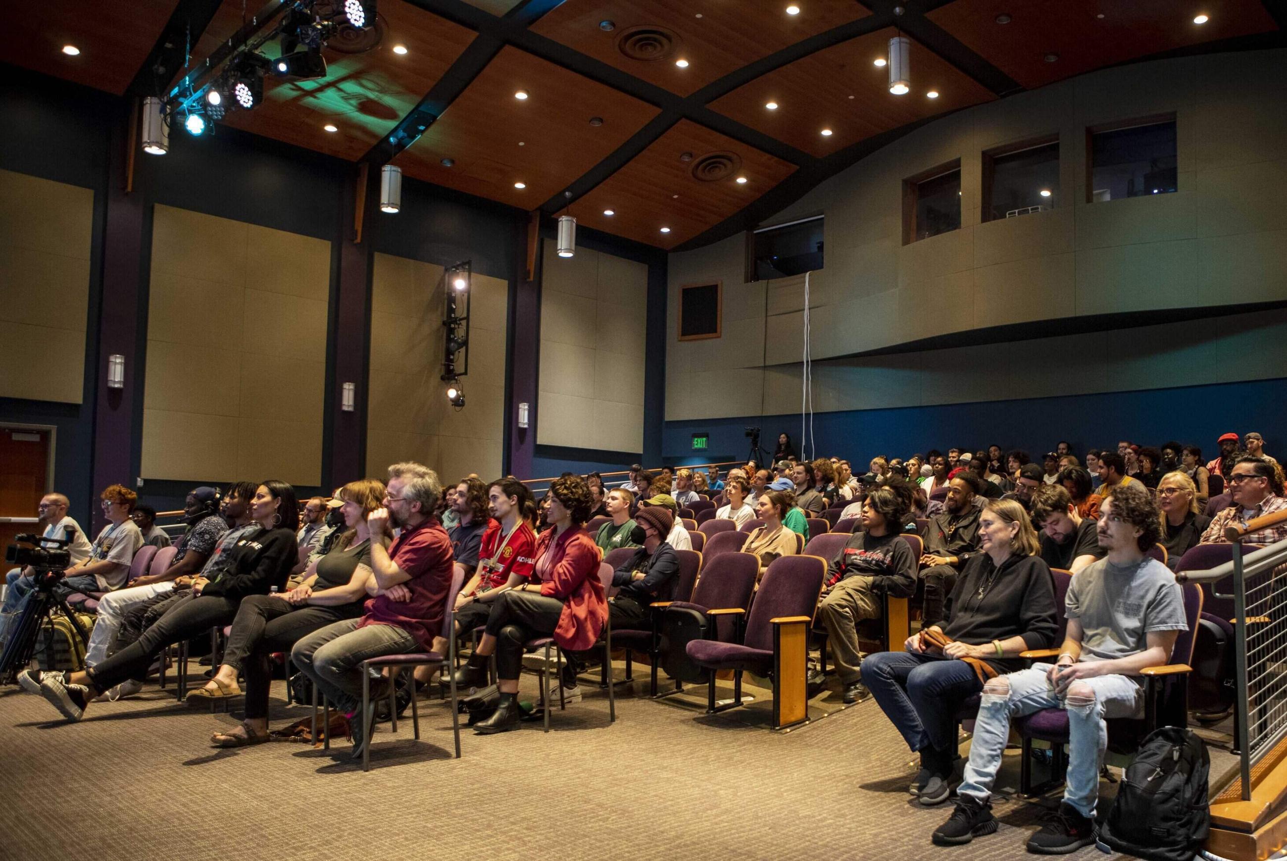 Auditorium full of people watching the stage
