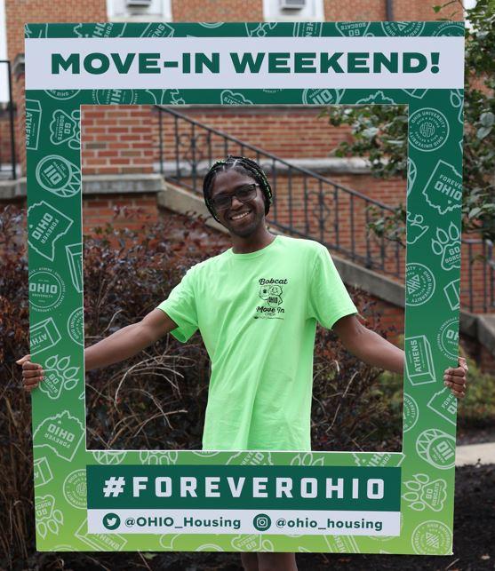 Charles Sanders holding move in sign