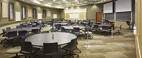 Classroom inside of Walter Hall, set up with round tables and chairs