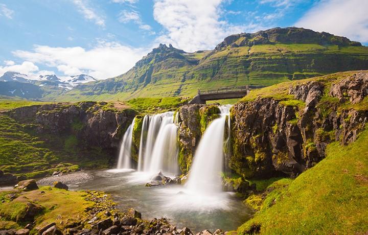 Beautiful green rocky mountain with waterfall.