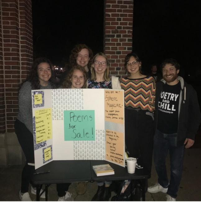 Sphere literary journal students holding up a presentation board