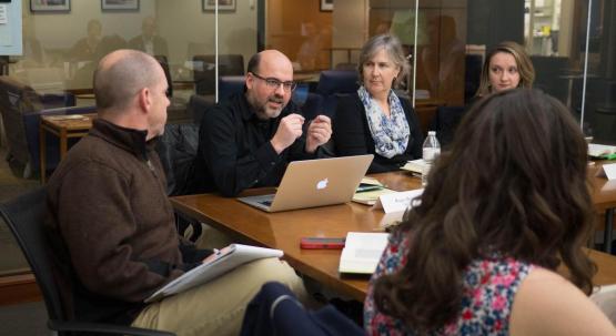 Faculty discuss topics during a BTA meeting