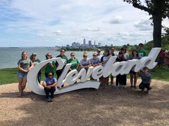 Group photo of Cleveland Bobcats in OHIO gear with Cleveland sign.