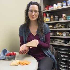 Dietitian holding portions in hand.