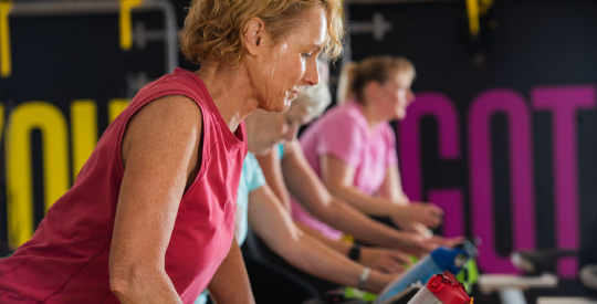 Member cycling at a group fitness class.