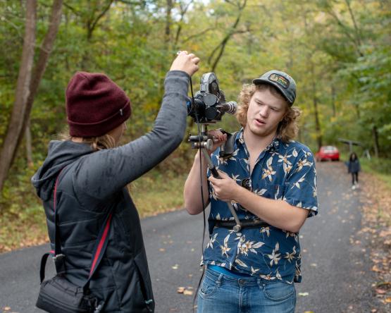 Two students set up a camera